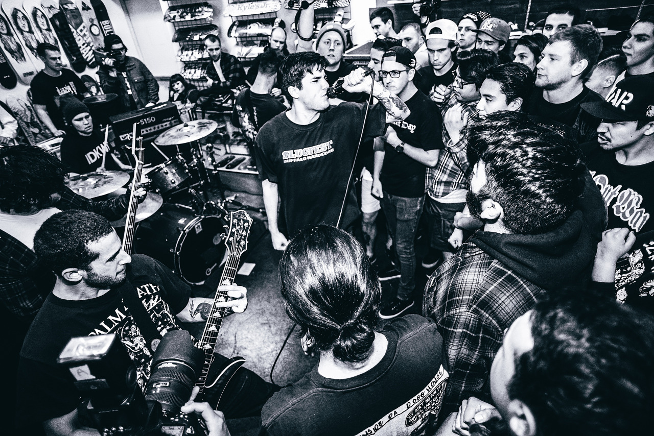 Black and white photo of Forced Order playing in front of a packed room. The photo was taken by Kiabad Meza.